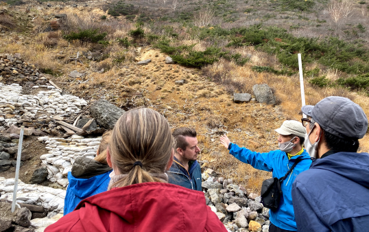 安達太良山の登山道でガイドに説明をうける人々